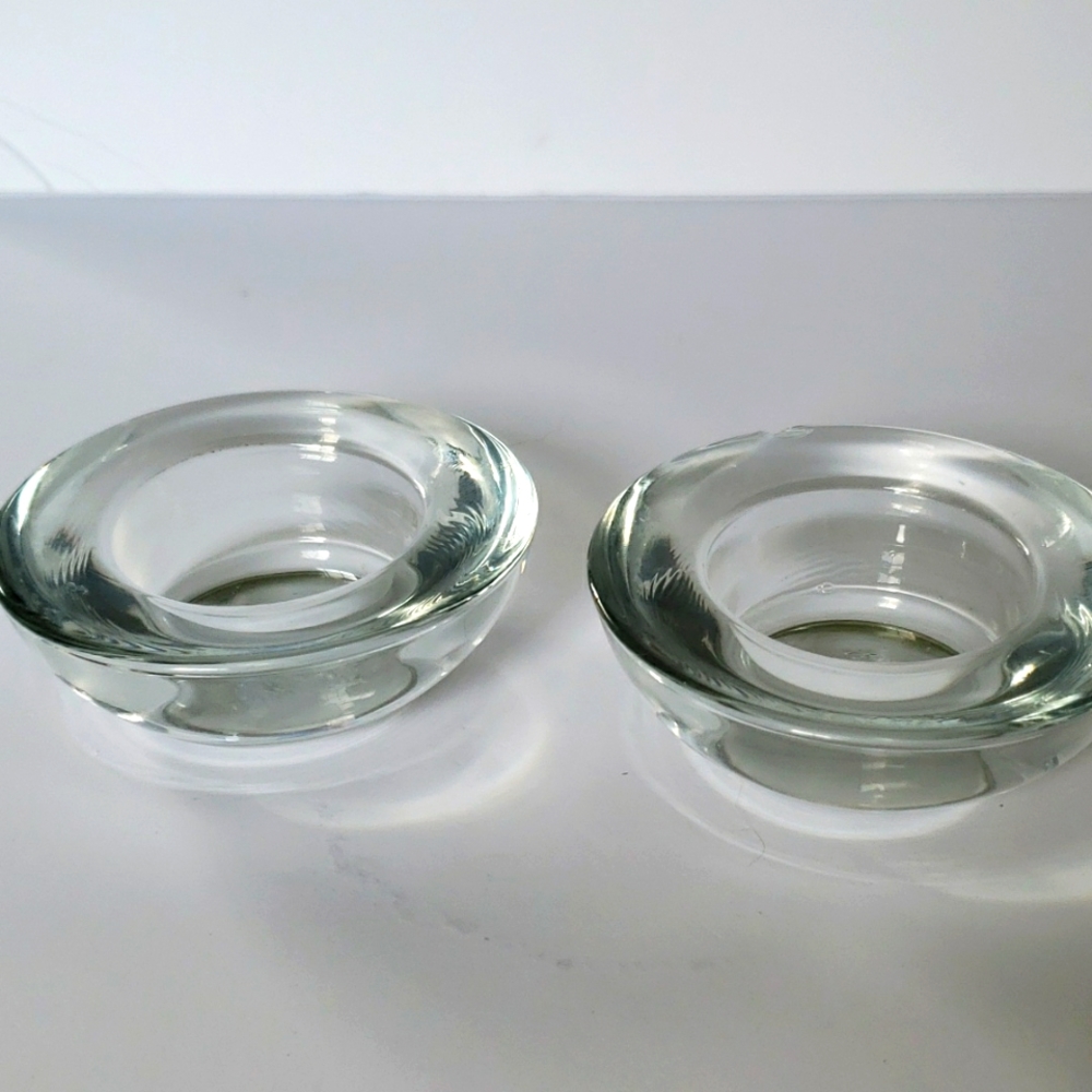 Two clear glass votive candle or tea light holders. Numbered on bottom